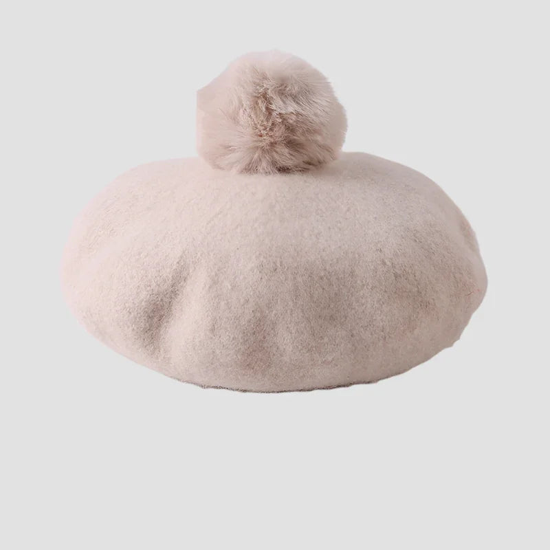 Beige beret with pompom.