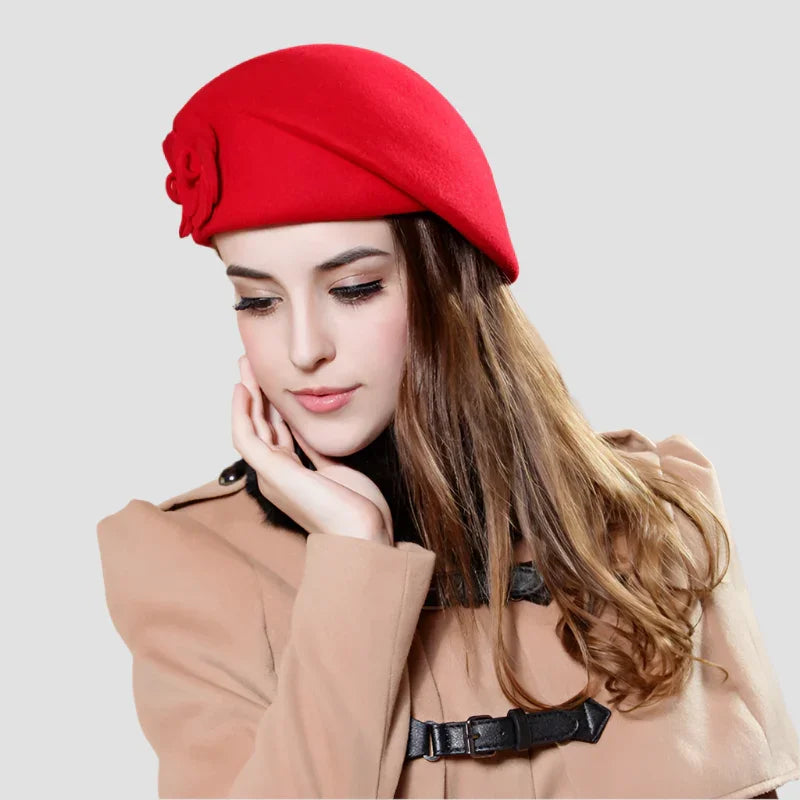 Red wool beret with flower detail.