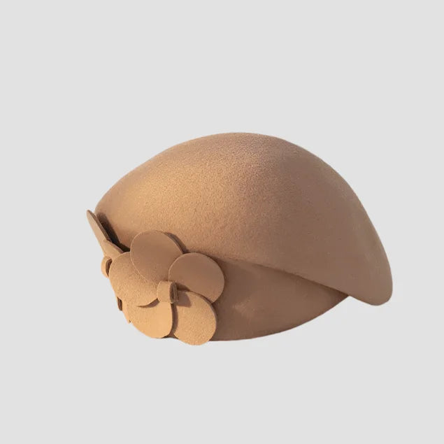 Tan felt hat with flower detail.