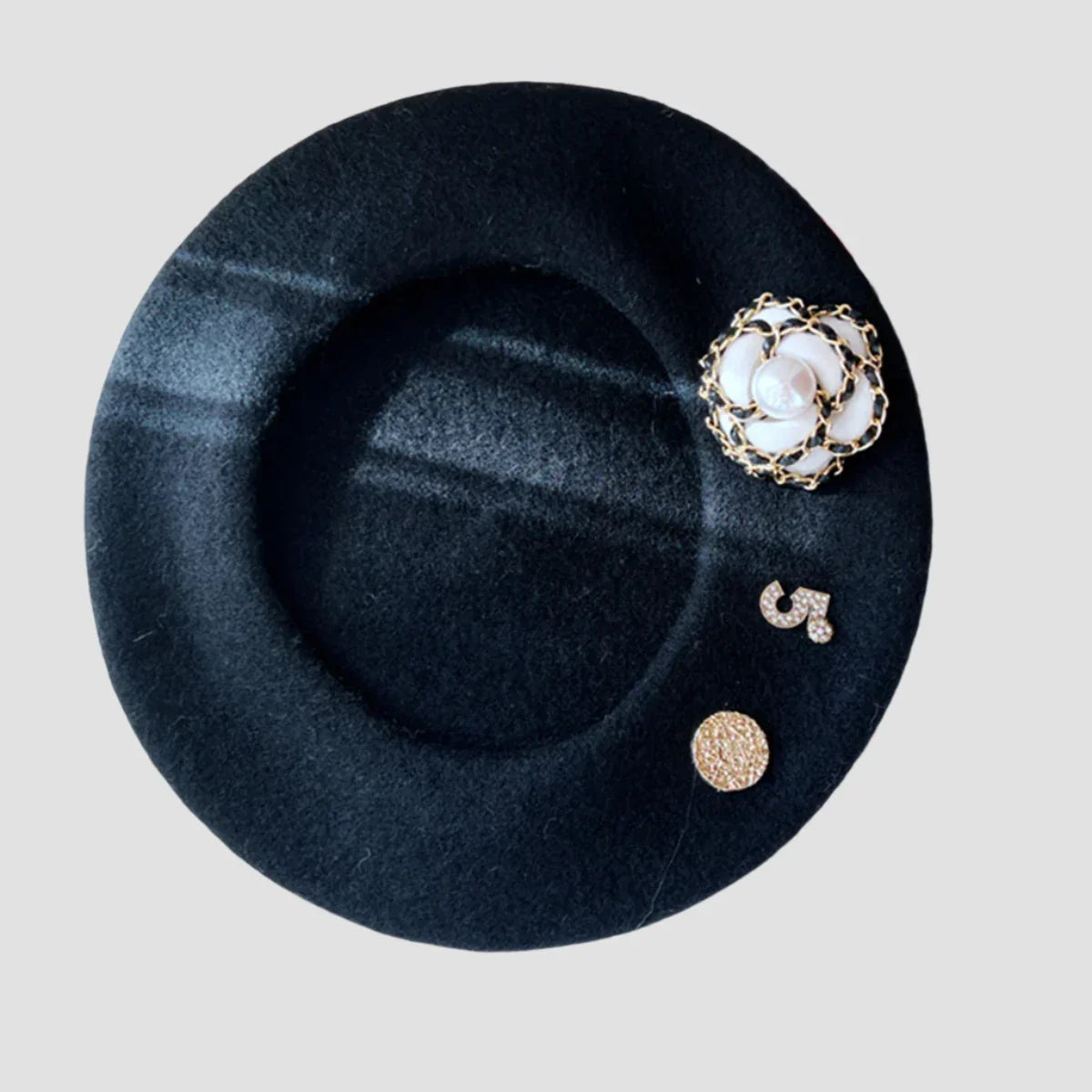 Black beret with decorative embellishments.