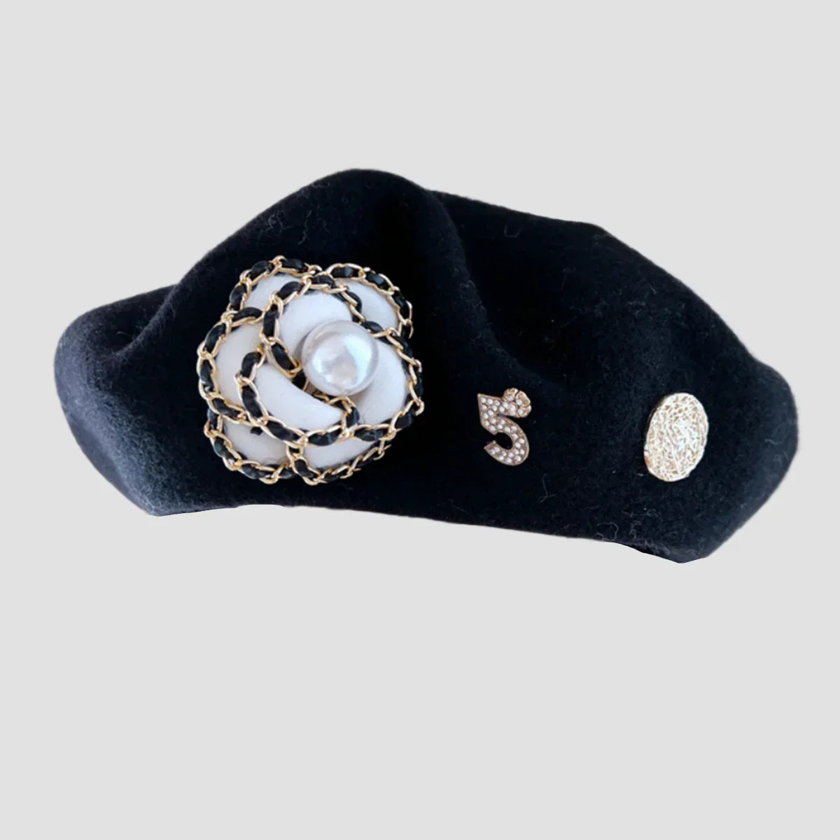 Black beret with flower and number embellishments.