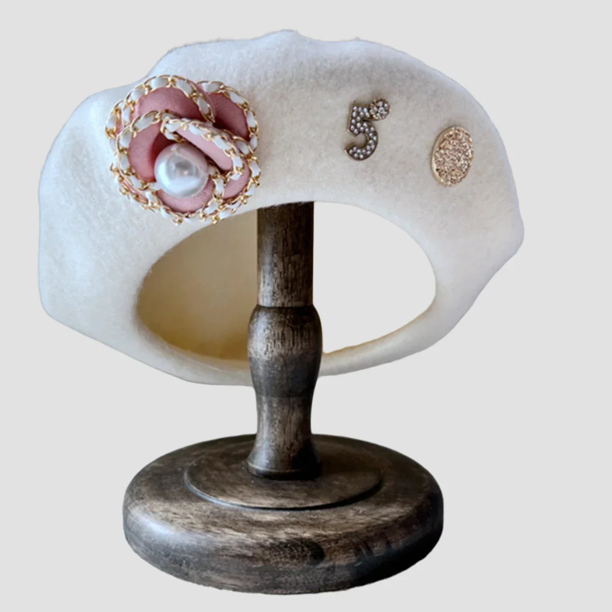 White beret with floral embellishment.
