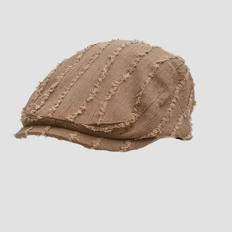 Brown newsboy cap with frayed stripes.