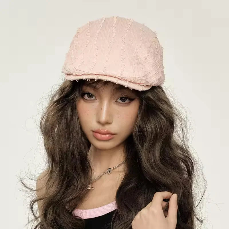 Pink textured newsboy cap.