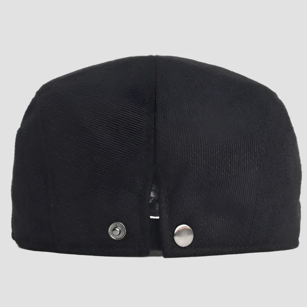 Black flat cap with snap closure.