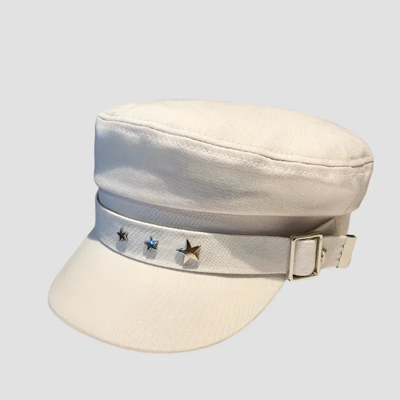 White peaked cap with star embellishments.