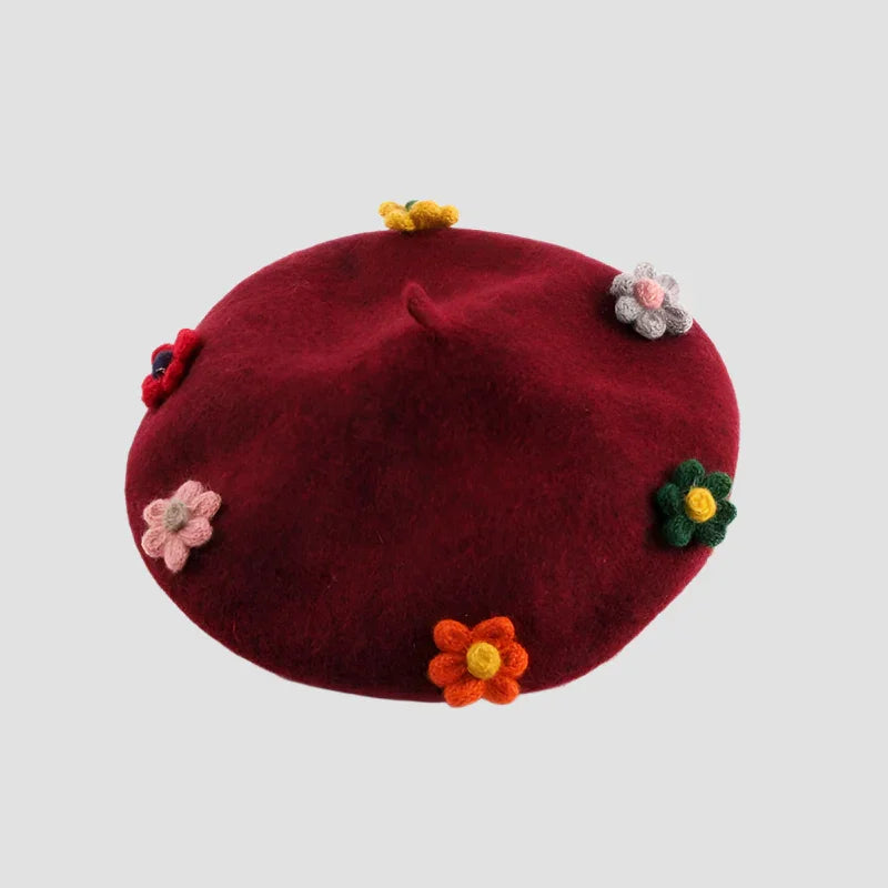 Burgundy beret with colorful crocheted flowers.