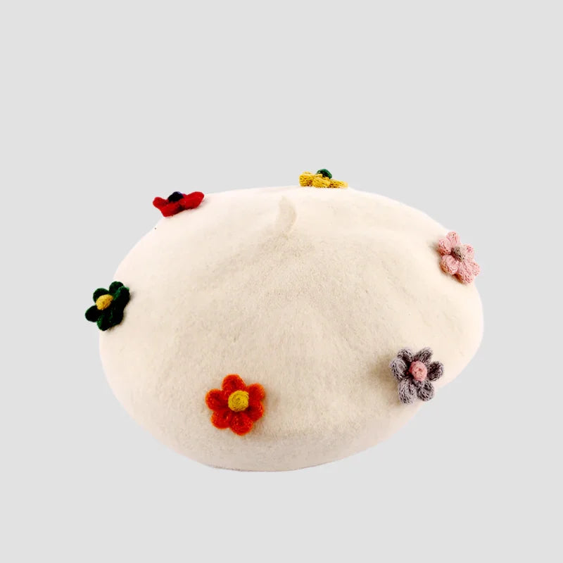 Cream-colored beret with colorful crocheted flowers.