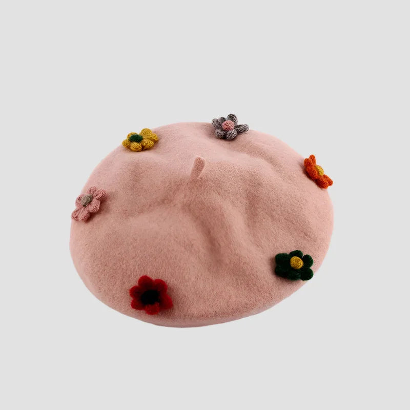 Pink beret with colorful crocheted flowers.