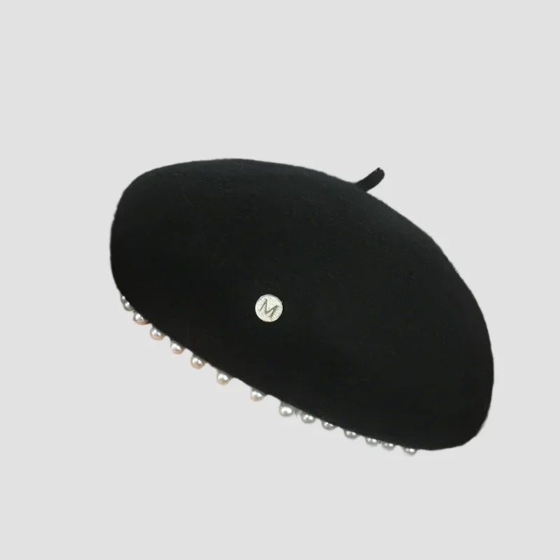 Black beret with pearl embellishments.