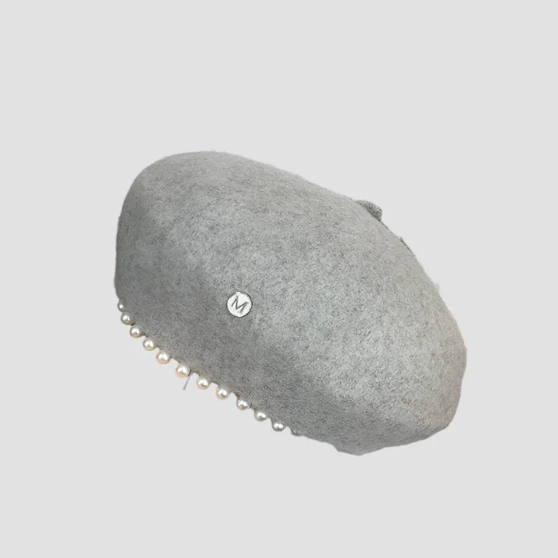 Gray beret with pearl embellishments.