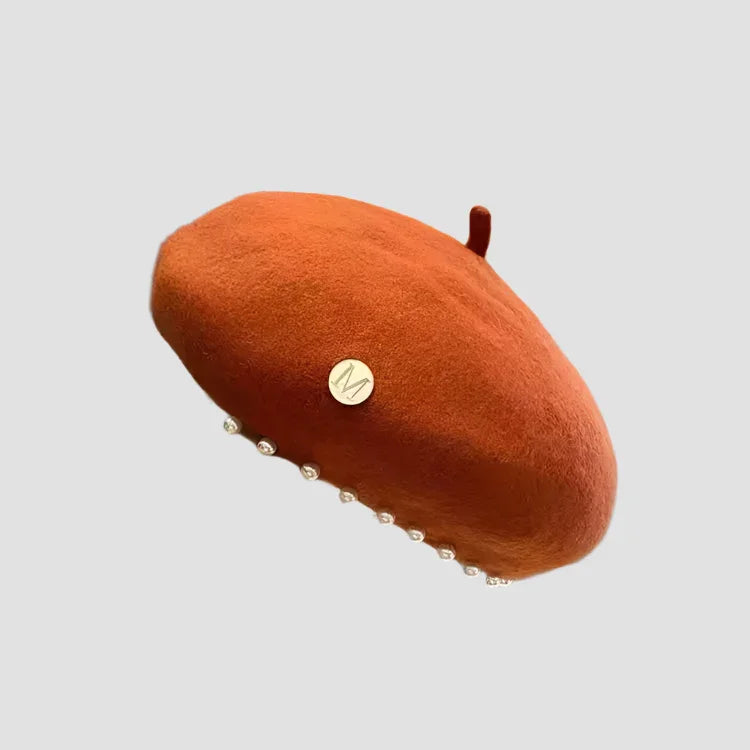 Orange beret with pearl trim.