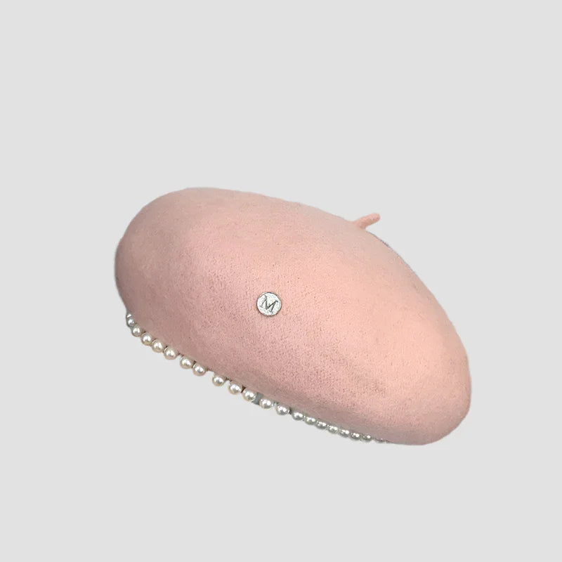 Pink beret with pearl trim.