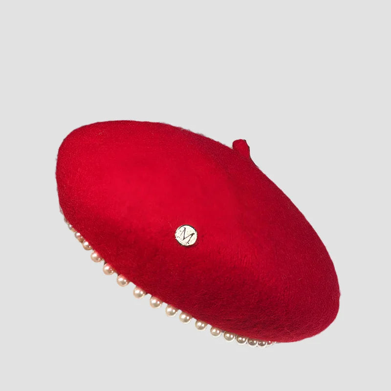 Red beret with pearl trim.