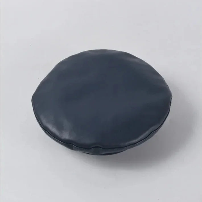 Round, navy blue cushion.