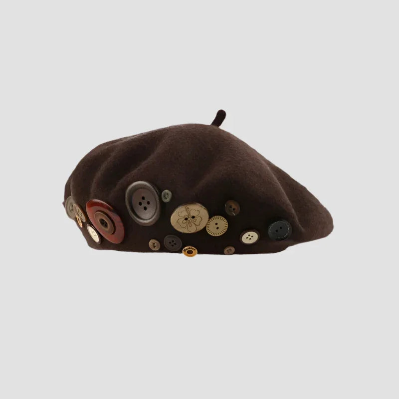 Brown beret adorned with buttons.
