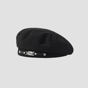 Black beret with decorative strap.
