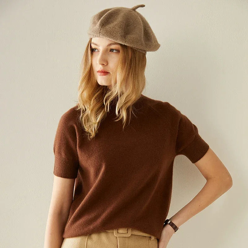 Woman in brown sweater and beret.