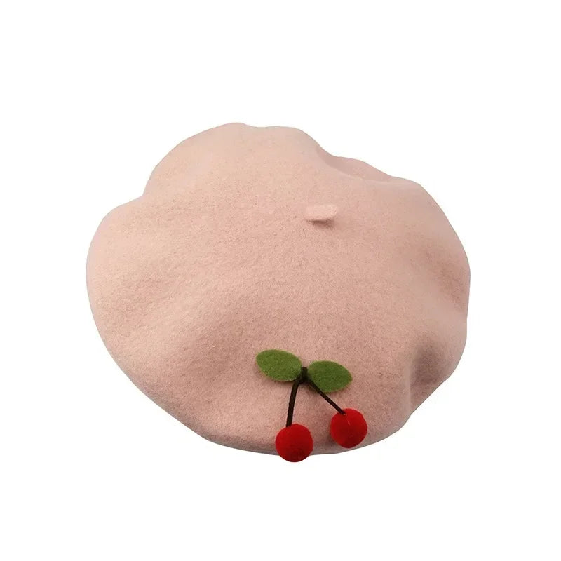 Pink beret with cherry embellishments.