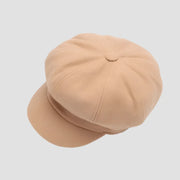 Beige newsboy cap.