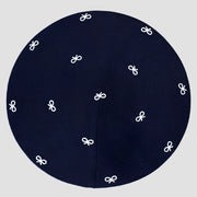 Navy blue kippah with white bow pattern.