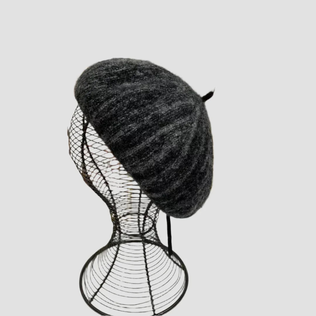 Gray wool beret on wire mannequin head.