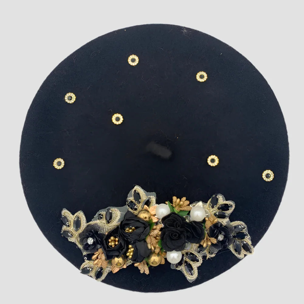 Black beret with floral embellishments.