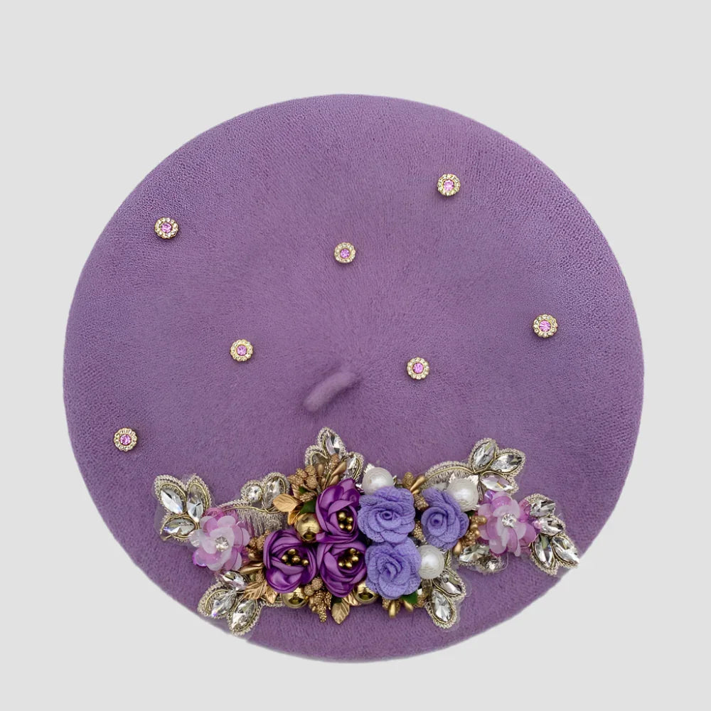 Lavender beret with floral embellishments.