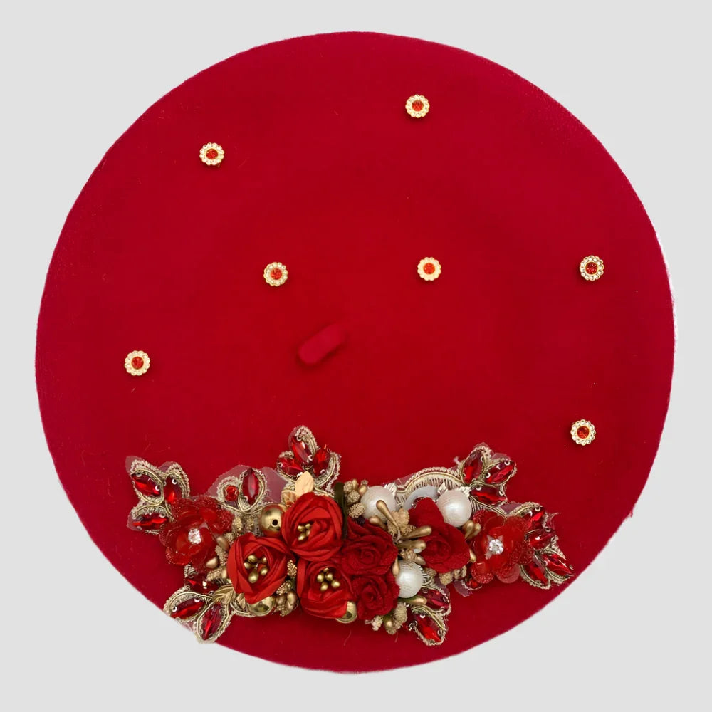 Red beret with floral embellishments.