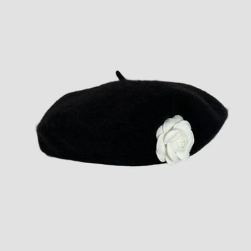 Black beret with white flower.