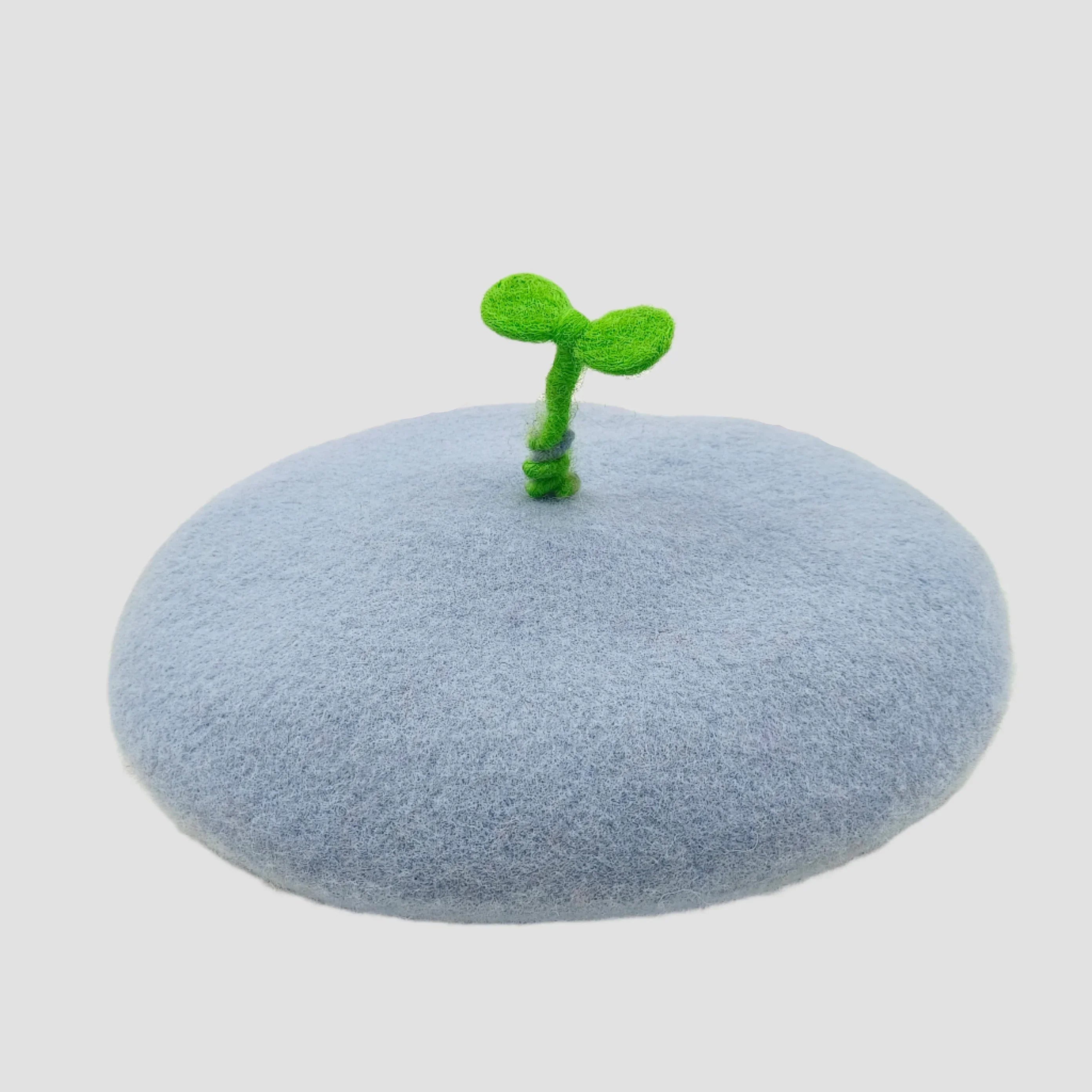 Light blue beret with green sprout.