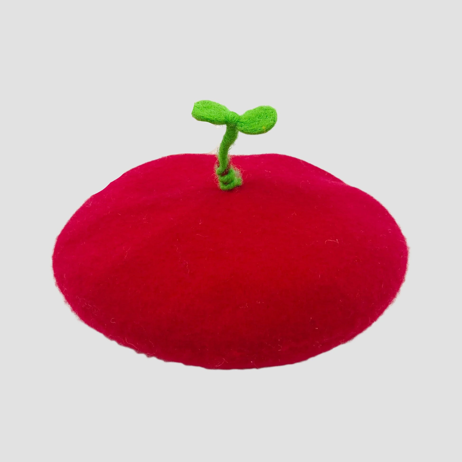 Red, plush, beret-style hat with green sprout.