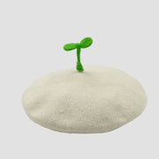 White beret with green sprout.