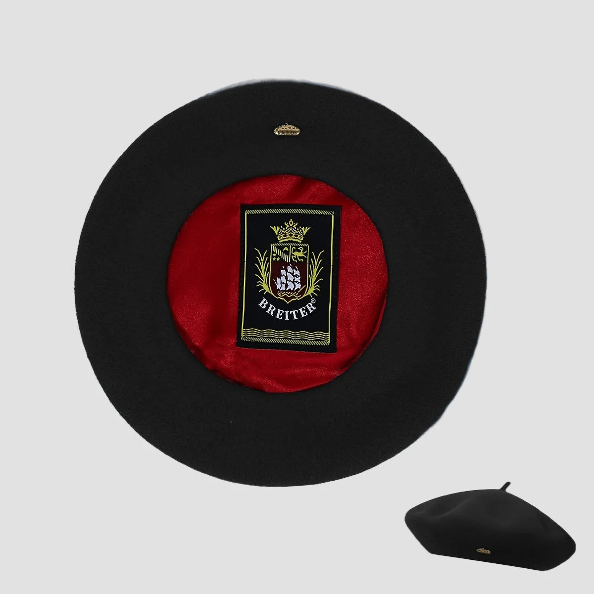 Black beret with red interior and visible brand logo on a light gray background