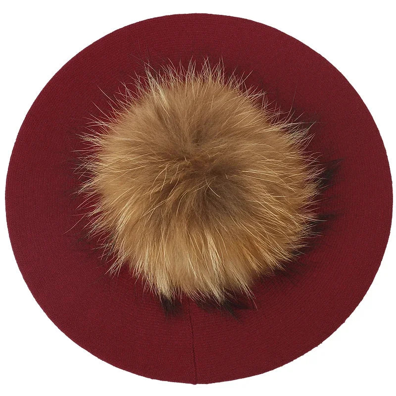 Maroon beret with fur pompom.