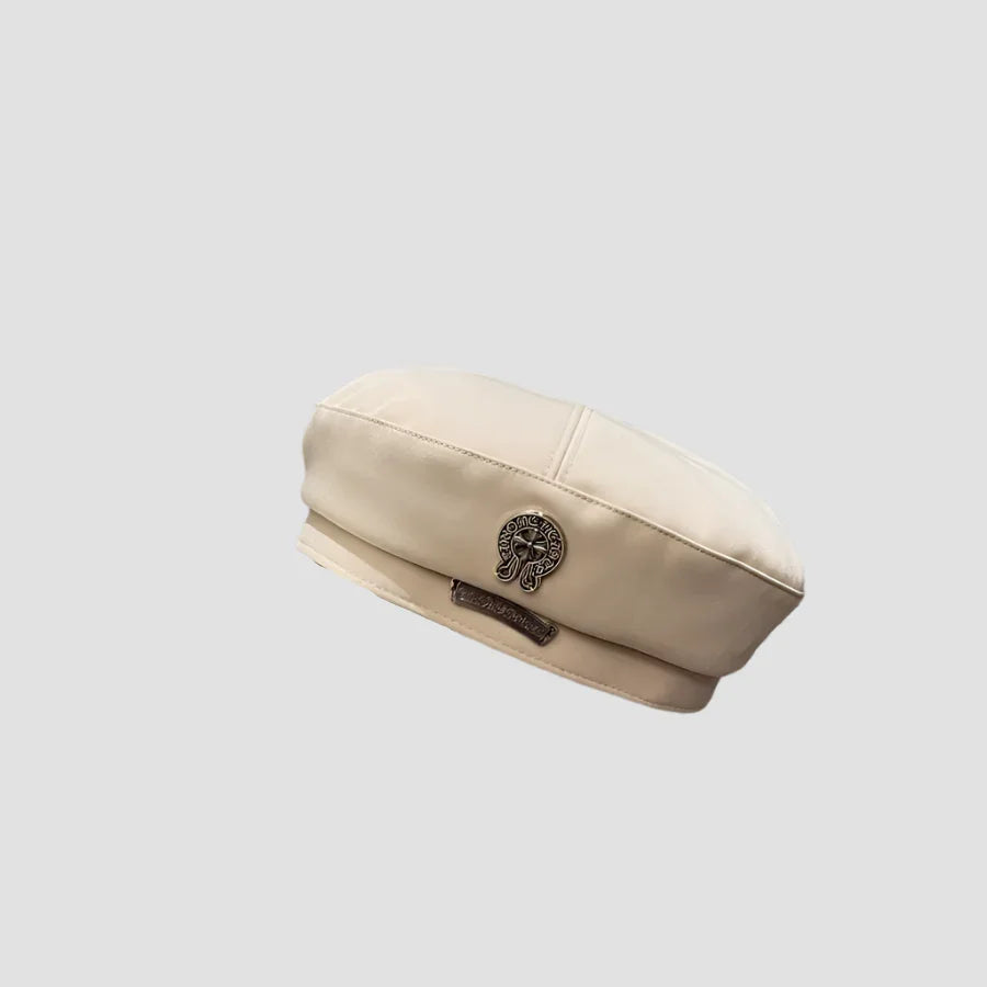 Cream-colored beret with metal embellishments.