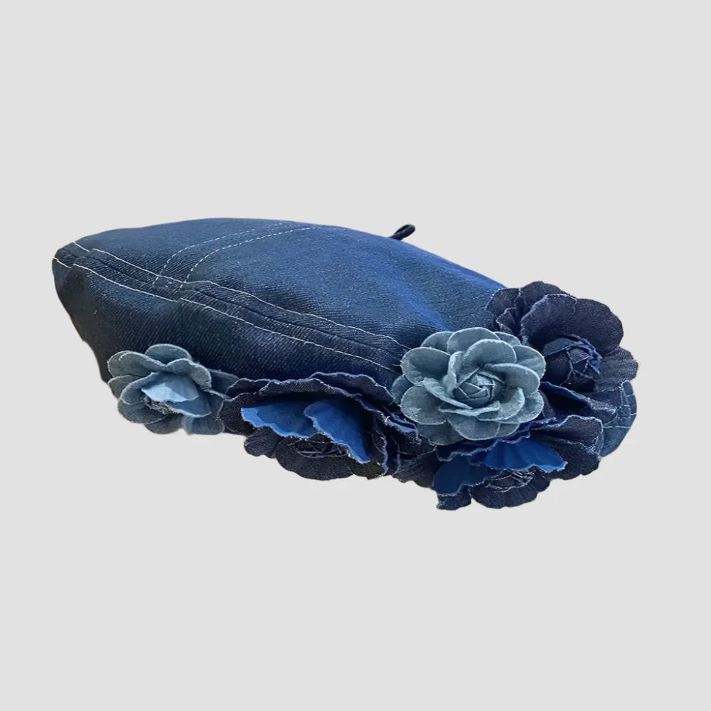 Denim beret with floral embellishments.