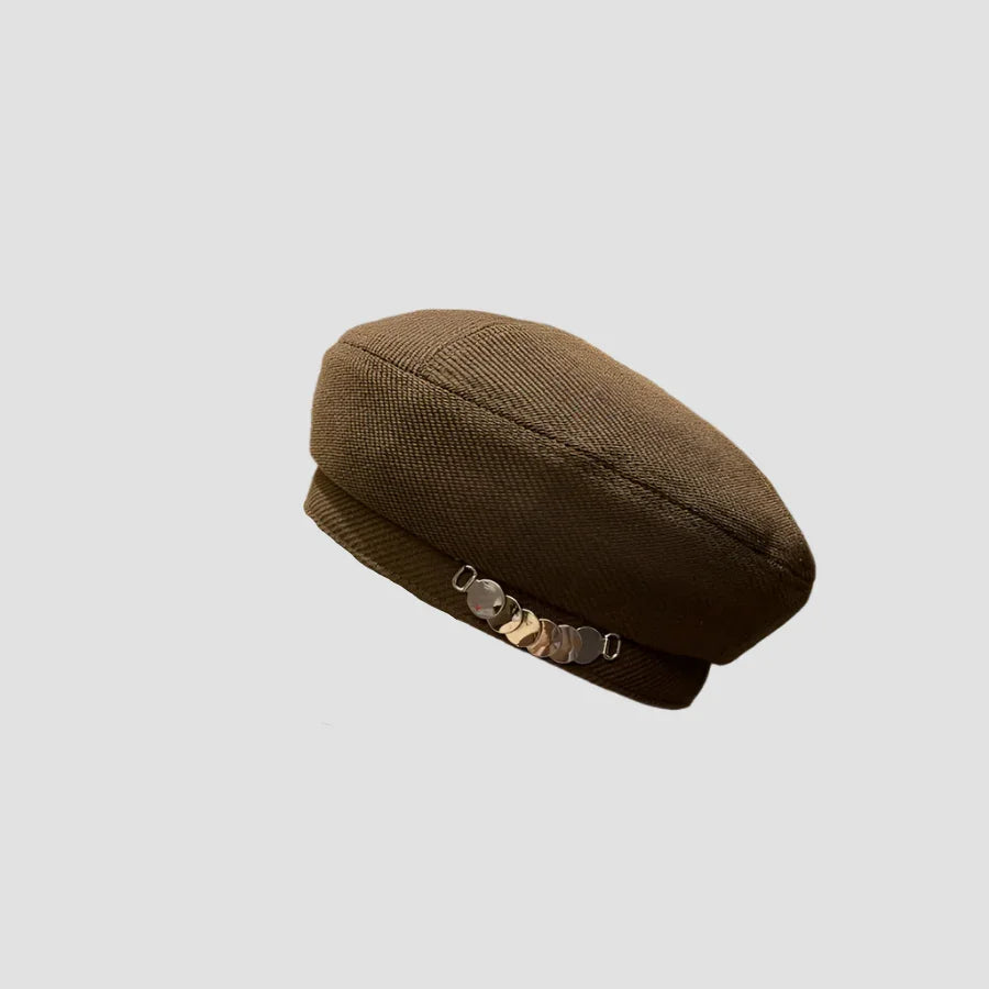 Olive-green beret with metallic embellishments.