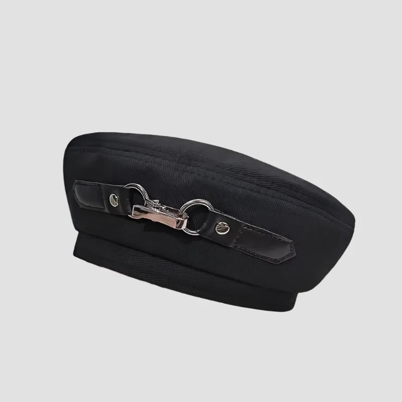 Black beret with decorative buckle.