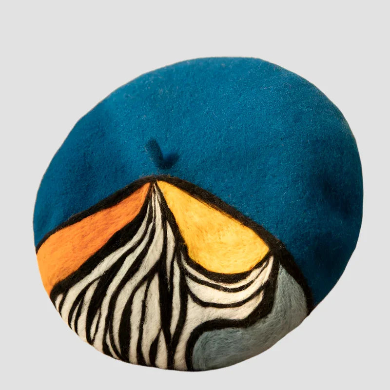 Blue beret with abstract mountain design.