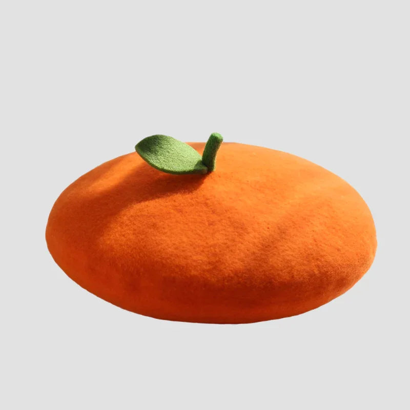 Orange beret with green leaf.