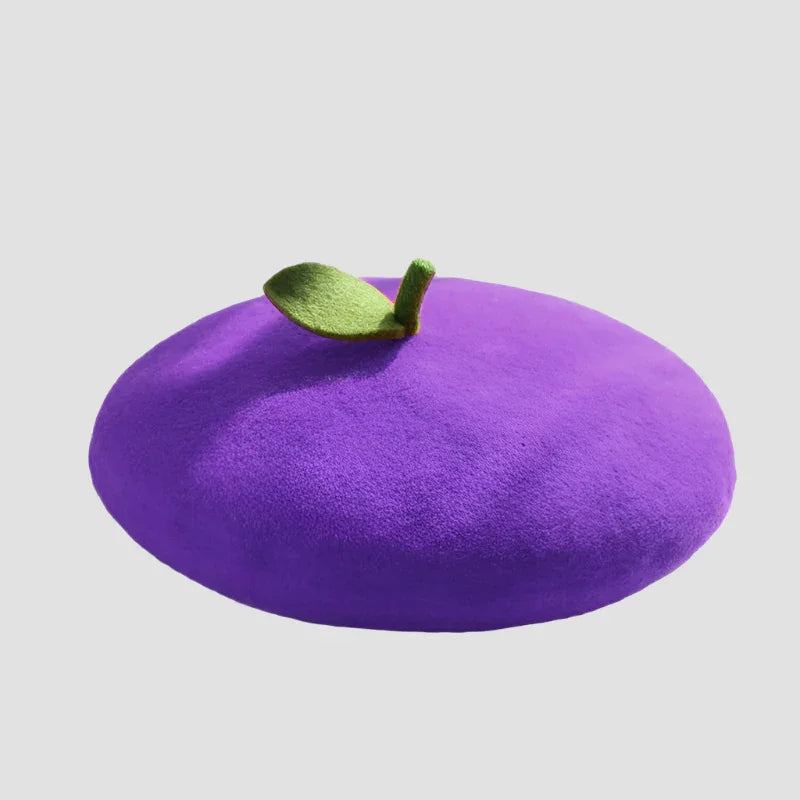 Purple beret with green leaf.