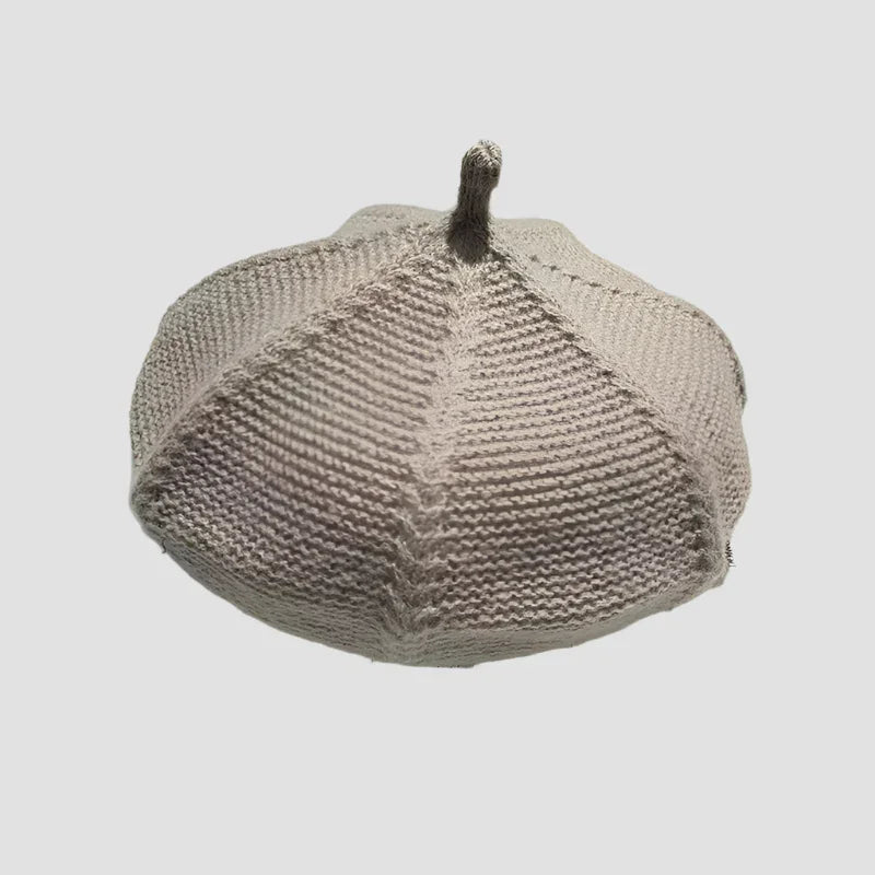 Knitted beige beret with stem.