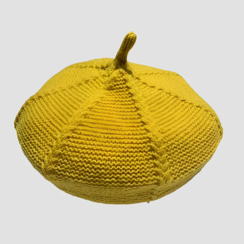 Yellow knitted beret with stem.