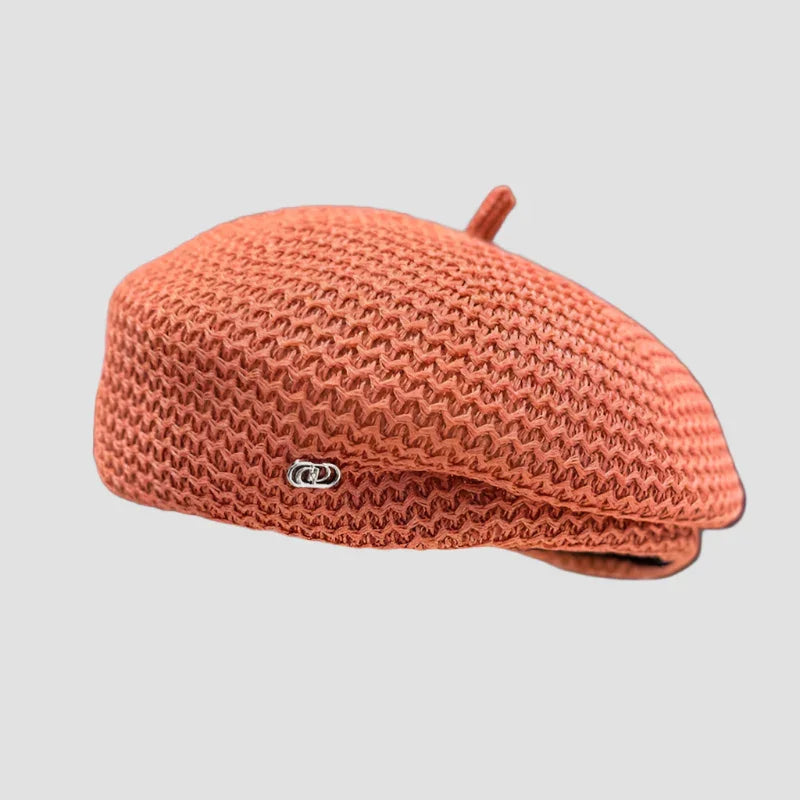 Knitted orange beret.