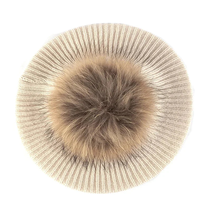 Knitted beret with fur pompom.