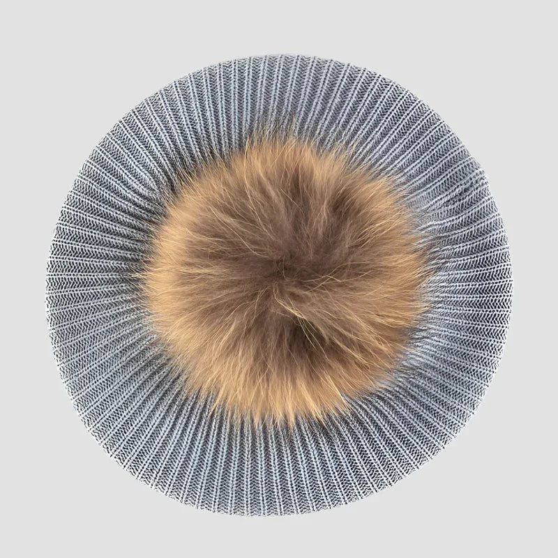 Knitted hat with fur pompom.