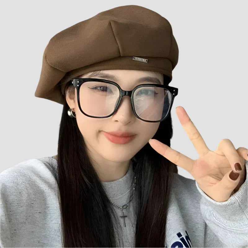 Brown beret with a metal accent.