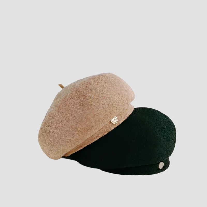 Two beret hats, one beige and one black.