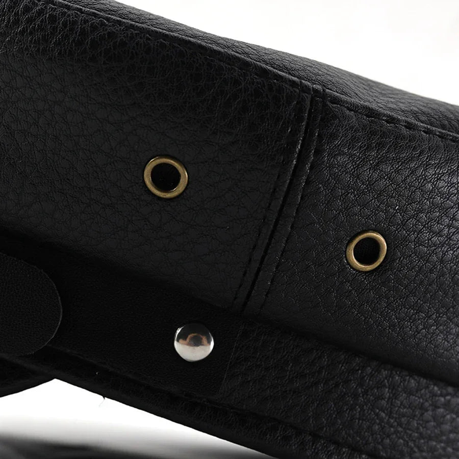 Black textured leather bag detail.